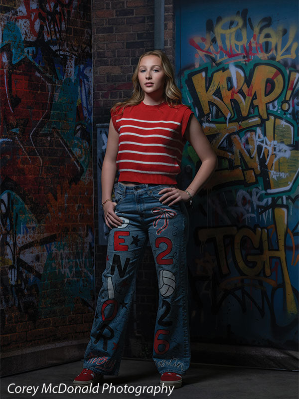 Keaton Graffiti Warehouse Door, photography backdrop panel for Denny StudioEdge silicone edge frame, shown with a senior girl in a red striped top with both hands on her hips SECP-8864