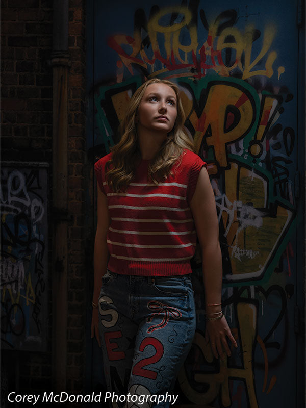 Keaton Graffiti Warehouse Door, photography backdrop panel for Denny StudioEdge silicone edge frame, shown with a senior girl in a red striped top standing and looking upward SECP-8864