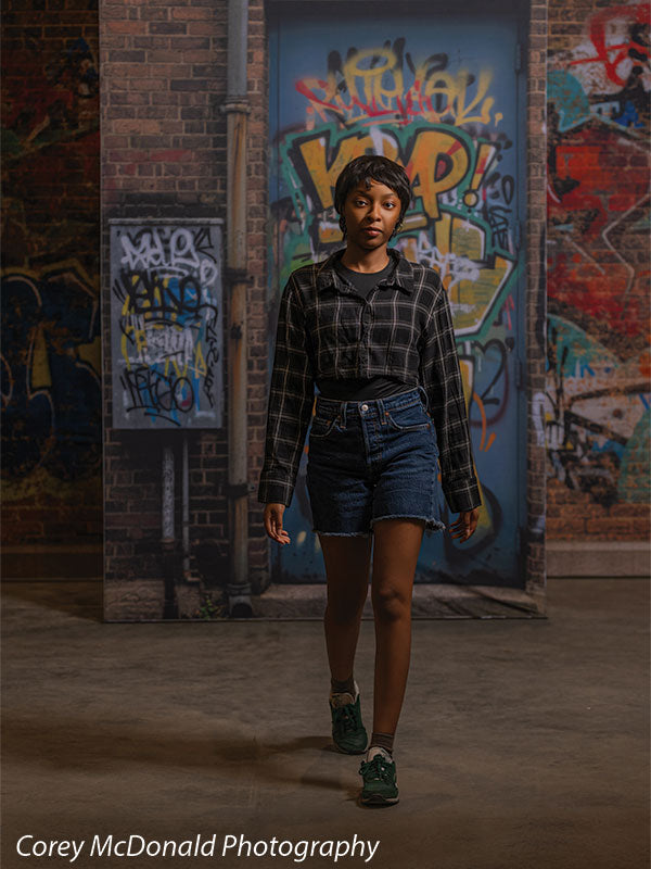 Keaton Graffiti Warehouse Door, photography backdrop panel for Denny StudioEdge silicone edge frame, shown with a senior girl standing full-length by the graffiti warehouse door SECP-8864
