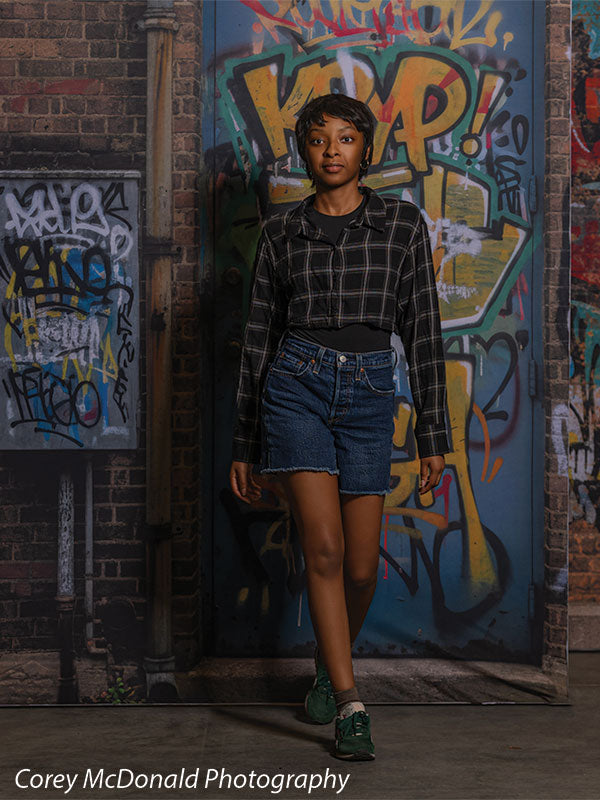 Keaton Graffiti Warehouse Door, photography backdrop panel for Denny StudioEdge silicone edge frame, shown with a senior girl stepping forward past the graffiti warehouse door SECP-8864