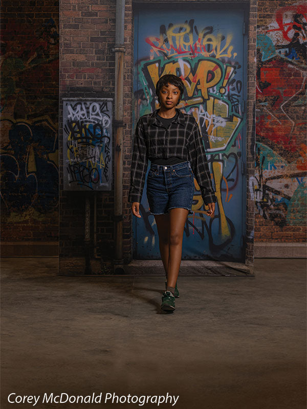 Keaton Graffiti Warehouse Door, photography backdrop panel for Denny StudioEdge silicone edge frame, shown with a senior girl walking forward from the graffiti warehouse door SECP-8864