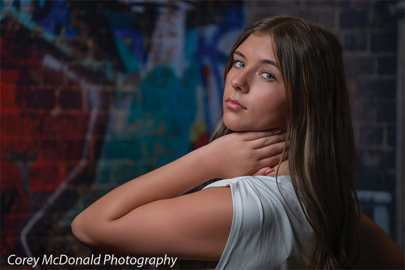 Keaton Graffiti Warehouse Door, photography backdrop panel for Denny StudioEdge silicone edge frame, shown with a senior girl glancing over her shoulder in a close portrait SECP-8864