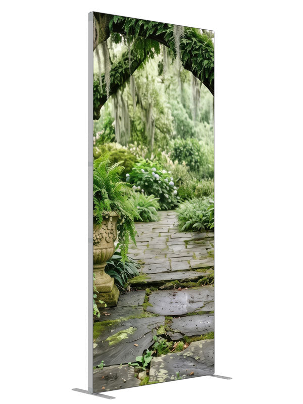 A mossy stone garden path beneath Spanish-moss live oaks with ferns and stone urns, 3ft photography backdrop panel for Denny StudioEdge silicone edge frame, angled view