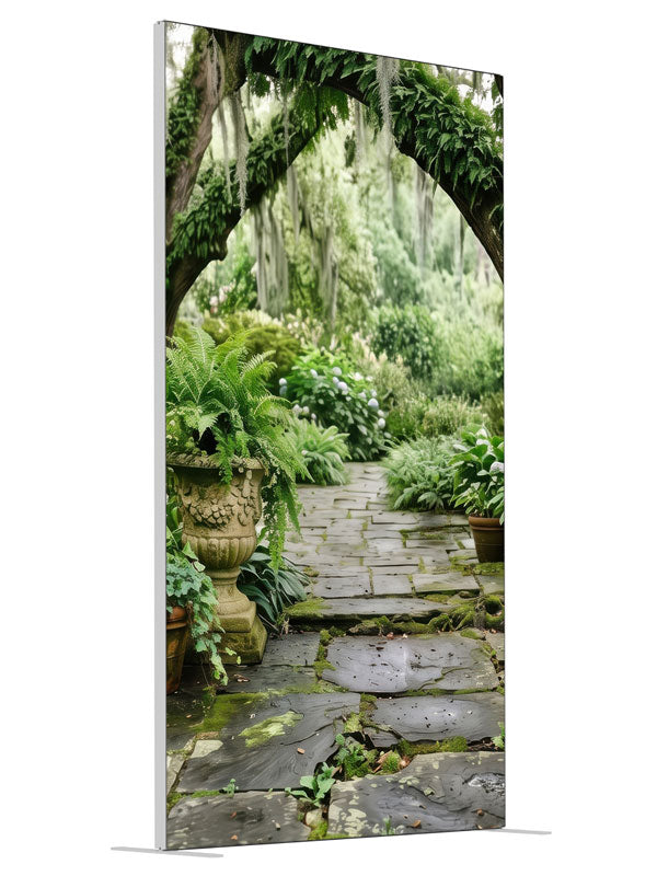 A mossy stone garden path beneath Spanish-moss live oaks with ferns and stone urns, 4ft photography backdrop panel for Denny StudioEdge silicone edge frame, angled view