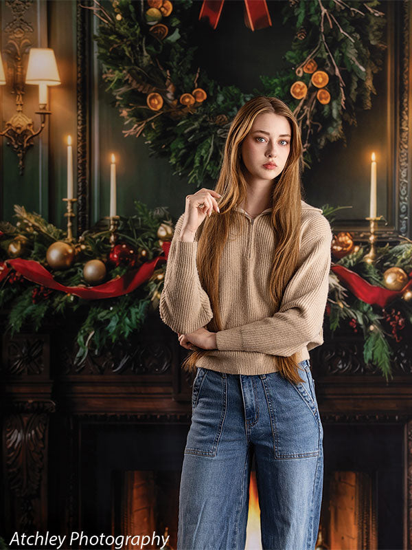 Manor Hearth dark wood fireplace with Christmas wreath photography backdrop shown with a senior girl standing with a hand near her collar CP-8885