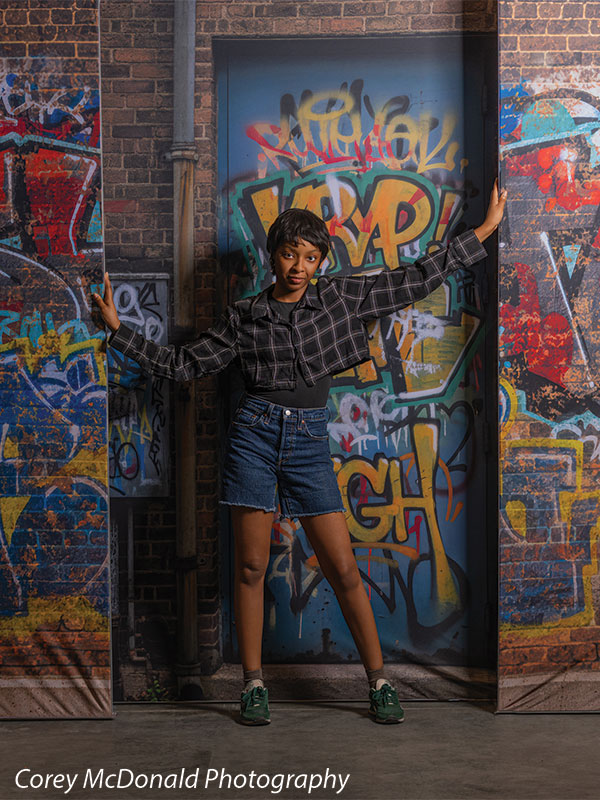 Marlowe Brick Wall Graffiti, photography backdrop panel for Denny StudioEdge silicone edge frame, shown with a senior girl with arms outstretched against the graffiti wall SECP-8863