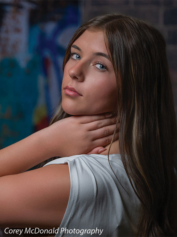 Marlowe Brick Wall Graffiti, photography backdrop panel for Denny StudioEdge silicone edge frame, shown with a senior girl in an off-shoulder white top in a close portrait SECP-8863