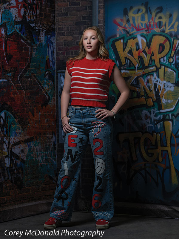 Marlowe Brick Wall Graffiti, photography backdrop panel for Denny StudioEdge silicone edge frame, shown with a senior girl in a red striped top with both hands on her hips SECP-8863