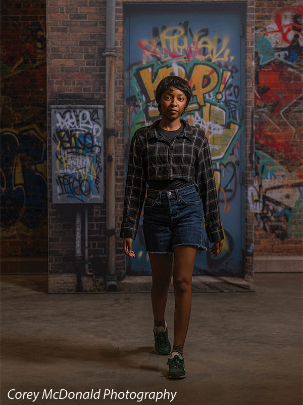 Marlowe Brick Wall Graffiti, photography backdrop panel for Denny StudioEdge silicone edge frame, shown with a senior girl standing full-length in front of the graffiti wall SECP-8863