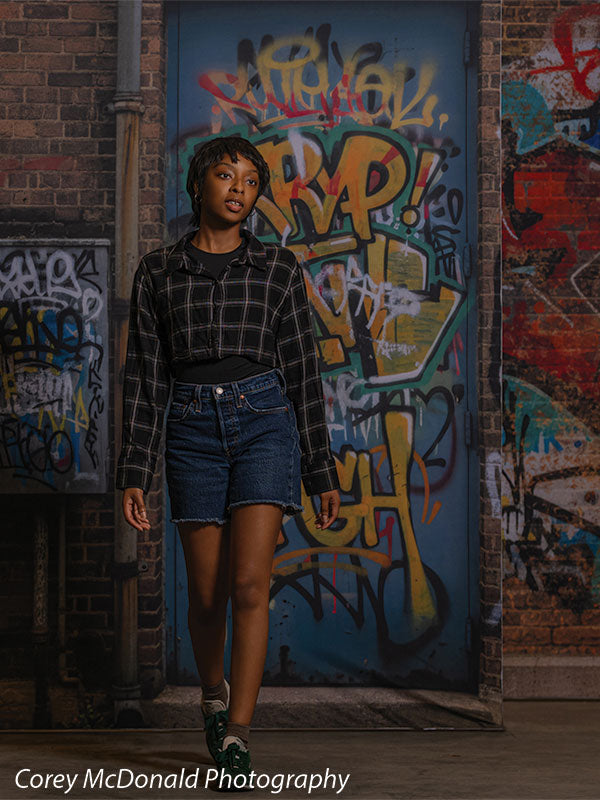 Marlowe Brick Wall Graffiti, photography backdrop panel for Denny StudioEdge silicone edge frame, shown with a senior girl standing in front of the graffiti wall, half-length SECP-8863