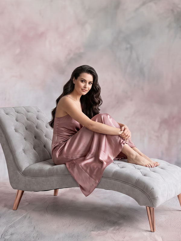 Mauve Smoke mauve mottled texture photography backdrop, shown with a woman in a rose satin dress seated barefoot on a gray chaise CP-9006