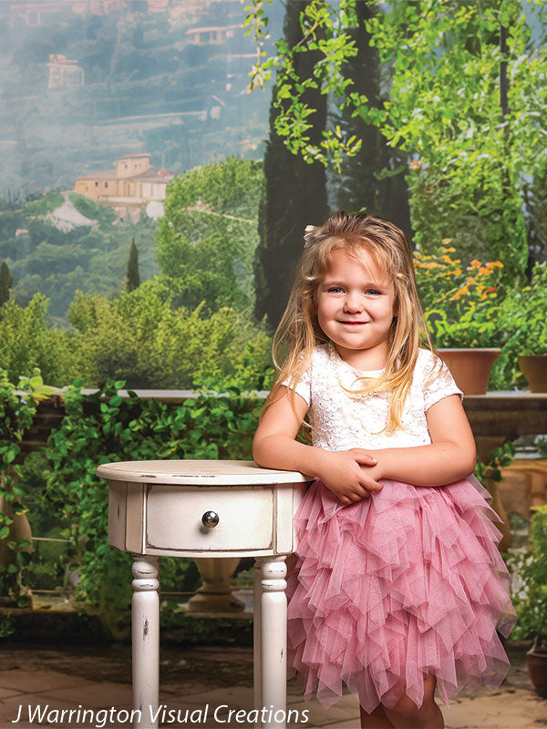 A scenic villa balcony photography backdrop featuring lush greenery and mountain views.