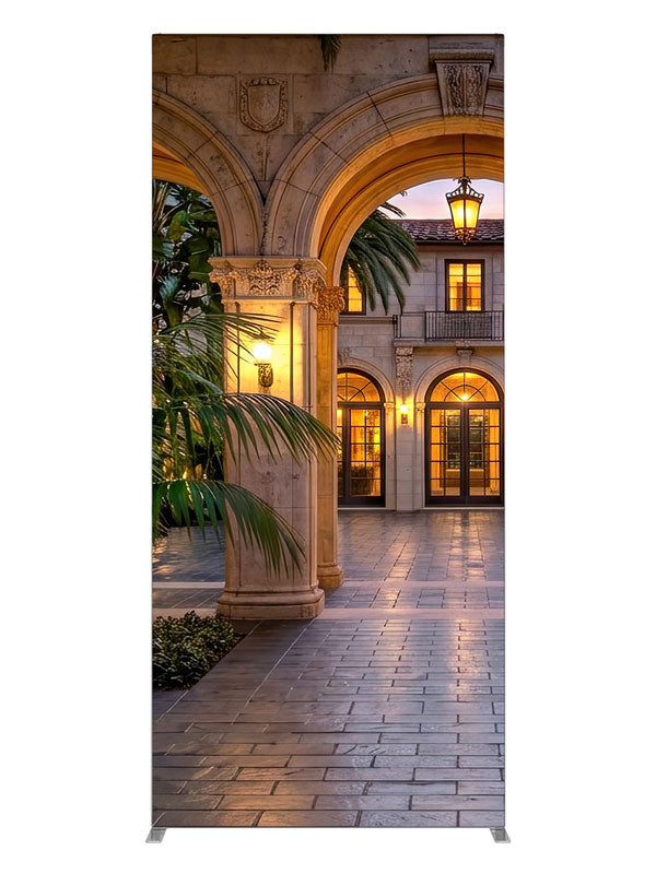 Grand stone archways opening onto a lantern-lit Mediterranean villa courtyard at dusk, 3ft photography backdrop panel for Denny StudioEdge silicone edge frame