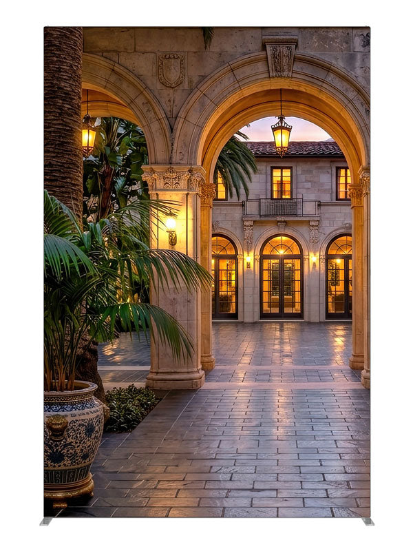 Grand stone archways opening onto a lantern-lit Mediterranean villa courtyard at dusk, 5ft photography backdrop panel for Denny StudioEdge silicone edge frame