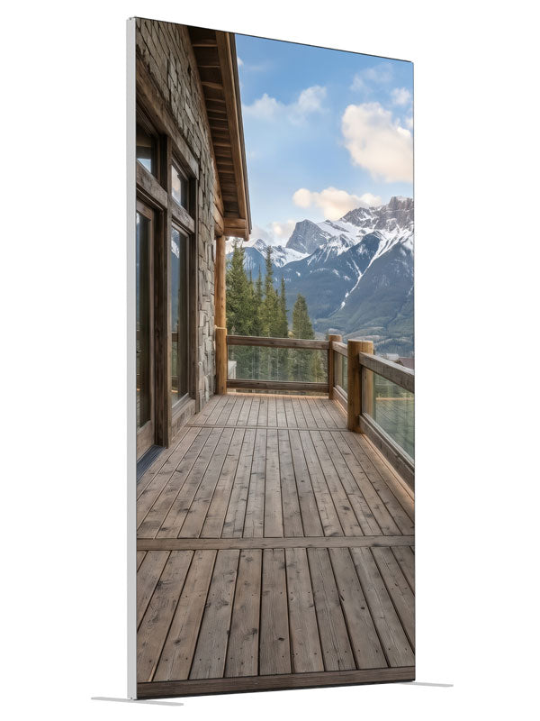 A rustic cabin deck overlooking pine forest and snow-capped mountains, 4ft photography backdrop panel for Denny StudioEdge silicone edge frame, angled view