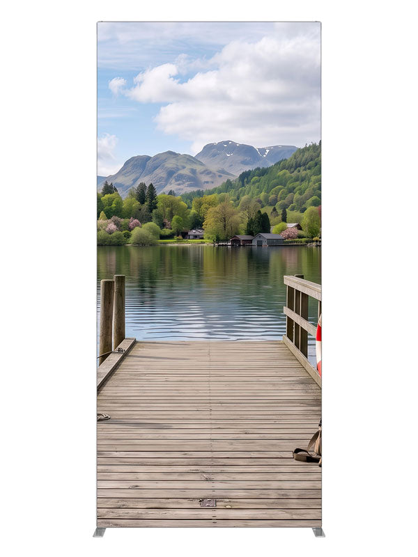 Weathered wooden dock running out into a calm mountain lake with a moored rowboat and a forested far shore, 3ft photography backdrop panel for Denny StudioEdge silicone edge frame