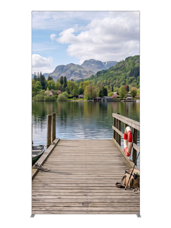 Weathered wooden dock running out into a calm mountain lake with a moored rowboat and a forested far shore, 4ft photography backdrop panel for Denny StudioEdge silicone edge frame
