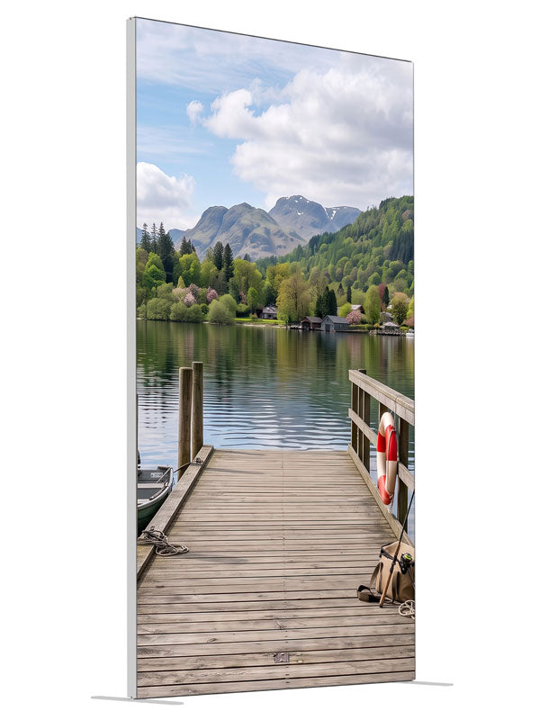 Weathered wooden dock running out into a calm mountain lake with a moored rowboat and a forested far shore, 4ft photography backdrop panel for Denny StudioEdge silicone edge frame, angled view