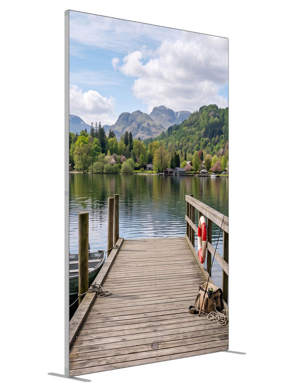 Weathered wooden dock running out into a calm mountain lake with a moored rowboat and a forested far shore, 5ft photography backdrop panel for Denny StudioEdge silicone edge frame, angled view