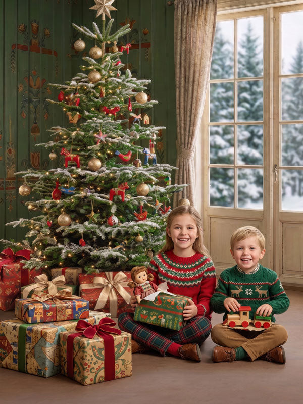 Nordic Noel Scandinavian green room with folk art walls and Christmas tree photography backdrop shown with two children seated on the floor with wooden toys CP-8903