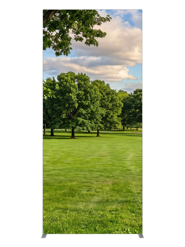 A broad open park lawn with a large shade tree and a distant tree line under a cloud-dotted sky, 3ft photography backdrop panel for Denny StudioEdge silicone edge frame