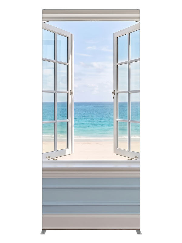 A white casement window open in a pale blue paneled wall onto a turquoise beach and sky, 3ft photography backdrop panel for Denny StudioEdge silicone edge frame