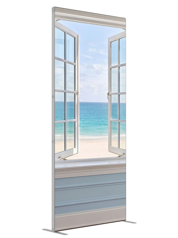 A white casement window open in a pale blue paneled wall onto a turquoise beach and sky, 3ft photography backdrop panel for Denny StudioEdge silicone edge frame, angled view