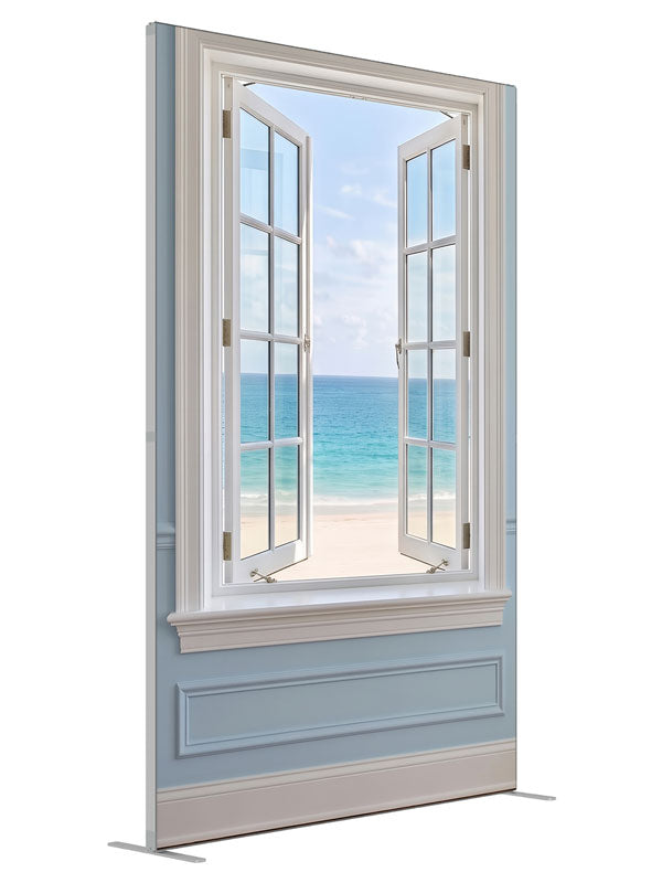 A white casement window open in a pale blue paneled wall onto a turquoise beach and sky, 5ft photography backdrop panel for Denny StudioEdge silicone edge frame, angled view