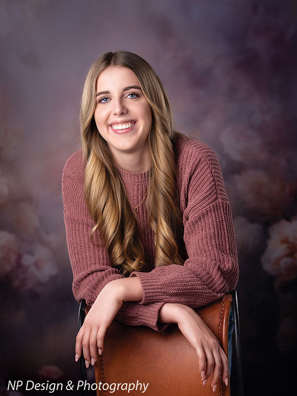 Peonies and roses photography backdrop shown with a senior girl in a mauve sweater leaning forward on a chair CP-8491