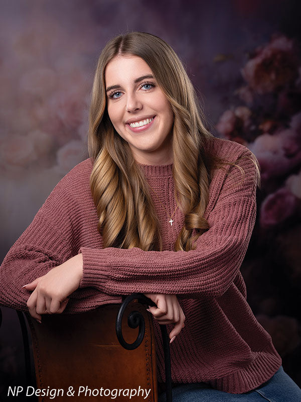 Peonies and roses photography backdrop shown with a senior girl in a mauve sweater leaning on the back of a wood chair in a close pose CP-8491