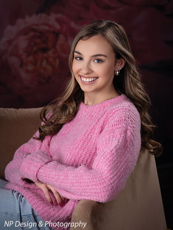 Peony bliss floral photography backdrop shown with seated with her arms crossed on the chair arm in a close portrait CP-8226