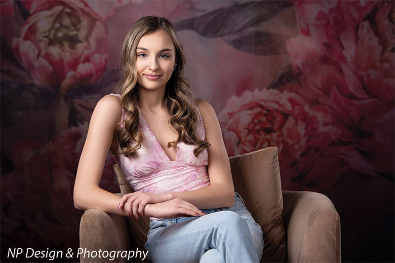 Peony bliss floral photography backdrop shown with in a pink halter top seated in a chair in a close pose CP-8226