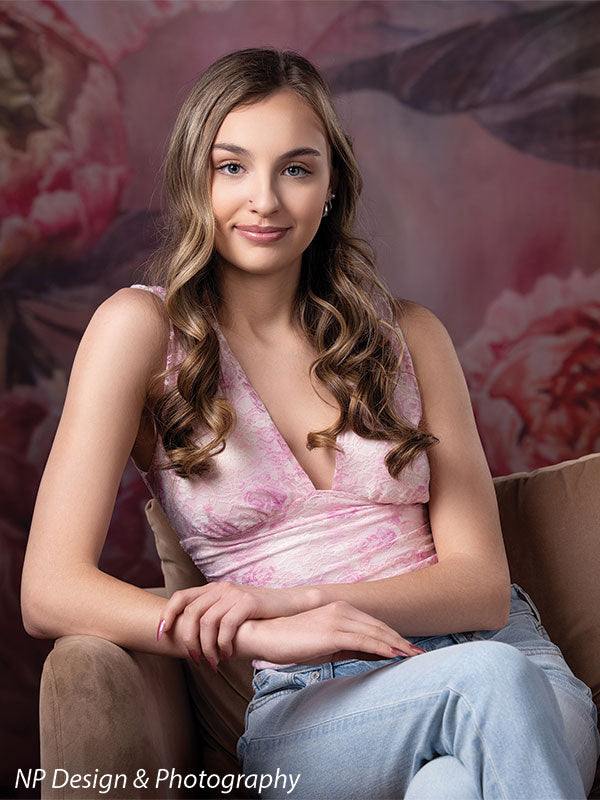 Peony bliss floral photography backdrop shown with in a pink halter top seated in a chair in a vertical portrait CP-8226