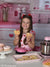 Charming Valentine's Day backdrop with pink gingham and heart-themed kitchen setting for photography studios and themed portraits.