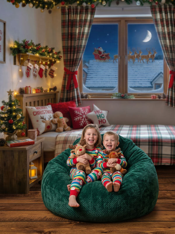 Plaid Dreams cozy Christmas bedroom with Santa sleigh window view photography backdrop shown with two children in striped pajamas on a green bean bag holding plush reindeer CP-8922