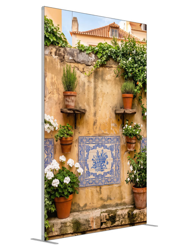 A warm ochre plaster wall with blue-and-white Portuguese tiles and potted geraniums, 5ft photography backdrop panel for Denny StudioEdge silicone edge frame, angled view