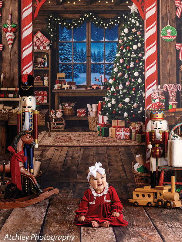 Reclaimed wood photography floor drop shown with a baby girl in a red dress seated on the reclaimed wood floor in a Christmas workshop scene FD-4070