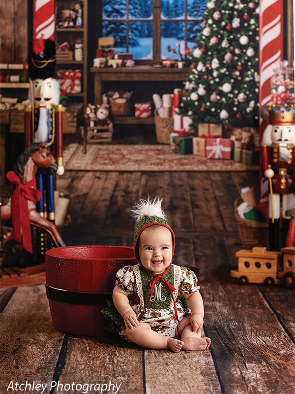 Reclaimed wood photography floor drop shown with a baby in a red Santa bucket on the reclaimed wood floor in a workshop scene FD-4070