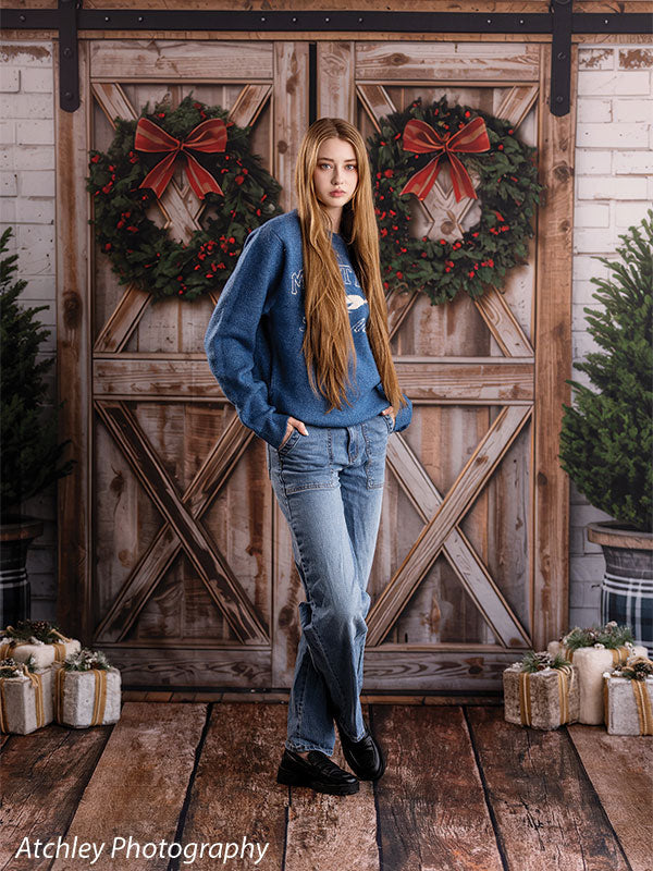 Reclaimed wood photography floor drop shown with a senior girl in a blue sweater standing on the reclaimed wood plank floor FD-4070