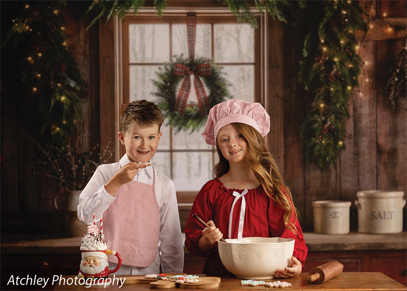 Red Cabin rustic Christmas kitchen photography backdrop shown with a boy and girl baking together at the counter in a wide view CP-8887