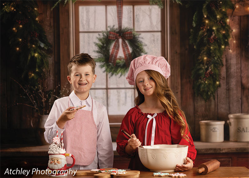Red Cabin rustic Christmas kitchen photography backdrop shown with a boy and girl mixing cookie dough at the counter, wide view CP-8887