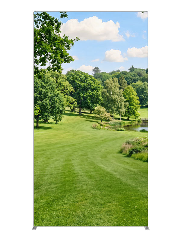 Naturalistic rolling parkland with a small pond, footbridge and wooded hills, 4ft photography backdrop panel for Denny StudioEdge silicone edge frame
