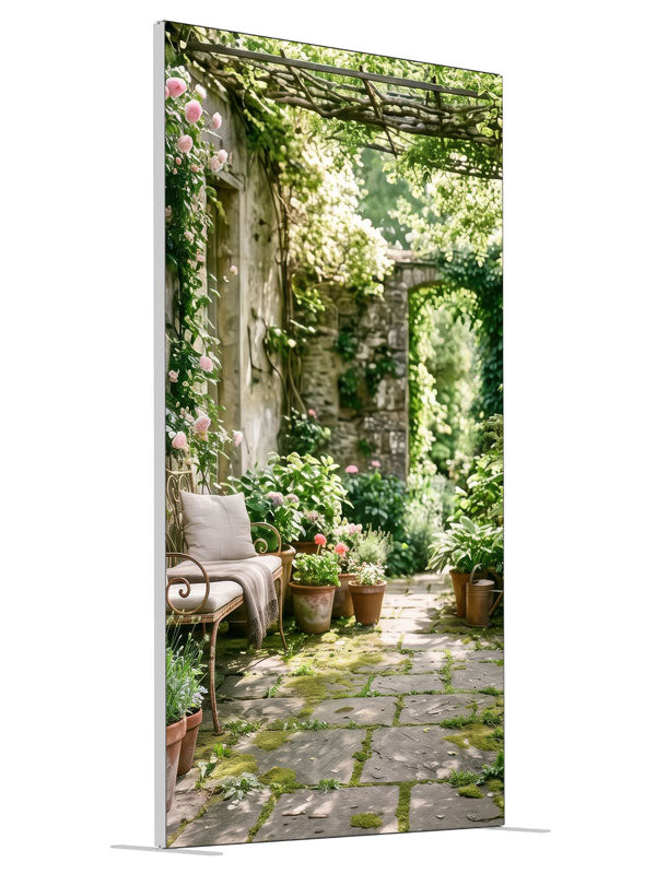 An English garden courtyard with a vine-draped pergola, climbing roses and a flagstone path to an arched doorway, 4ft photography backdrop panel for Denny StudioEdge silicone edge frame, angled view