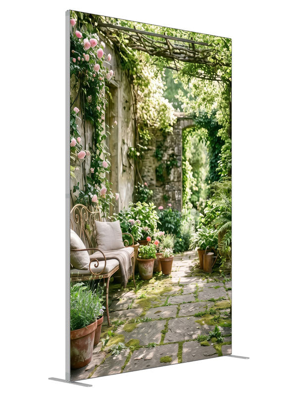 An English garden courtyard with a vine-draped pergola, climbing roses and a flagstone path to an arched doorway, 5ft photography backdrop panel for Denny StudioEdge silicone edge frame, angled view