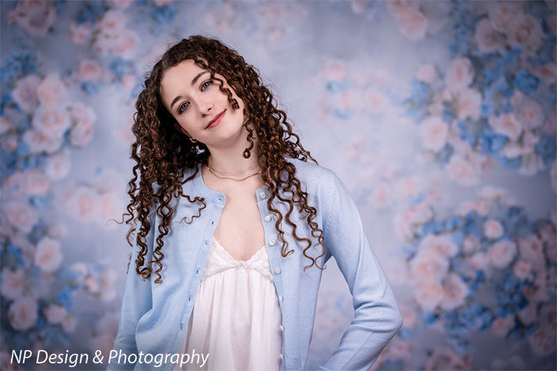 Rose master blue floral photography backdrop shown with in a close-up pose with her hands on her hips CP-7598