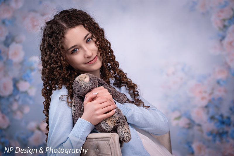 Rose master blue floral photography backdrop shown with holding a plush bunny to her chest CP-7598