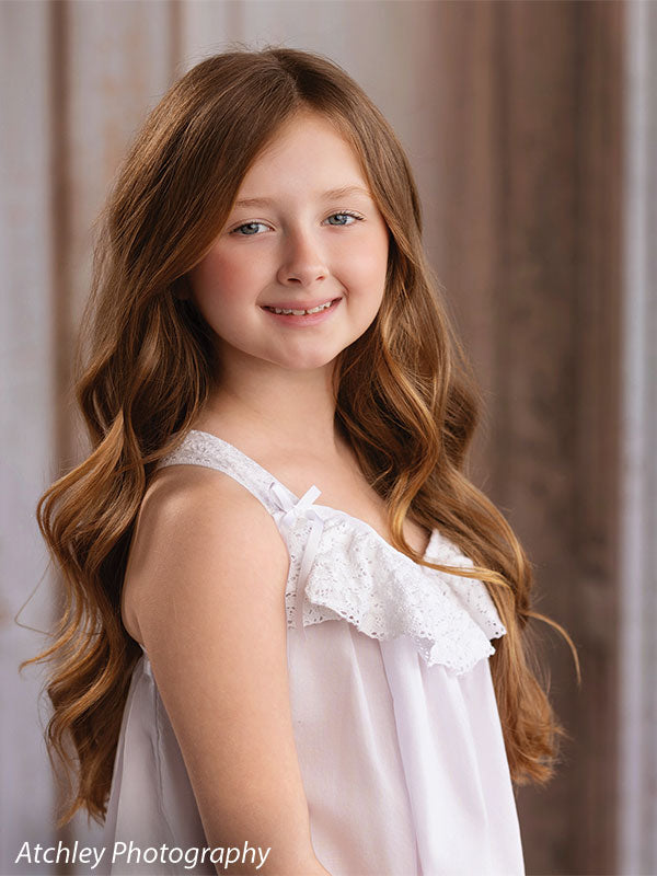 Rose Parlor distressed pink French double doors photography backdrop shown with a young girl in a white slip dress smiling in a close portrait CP-8793
