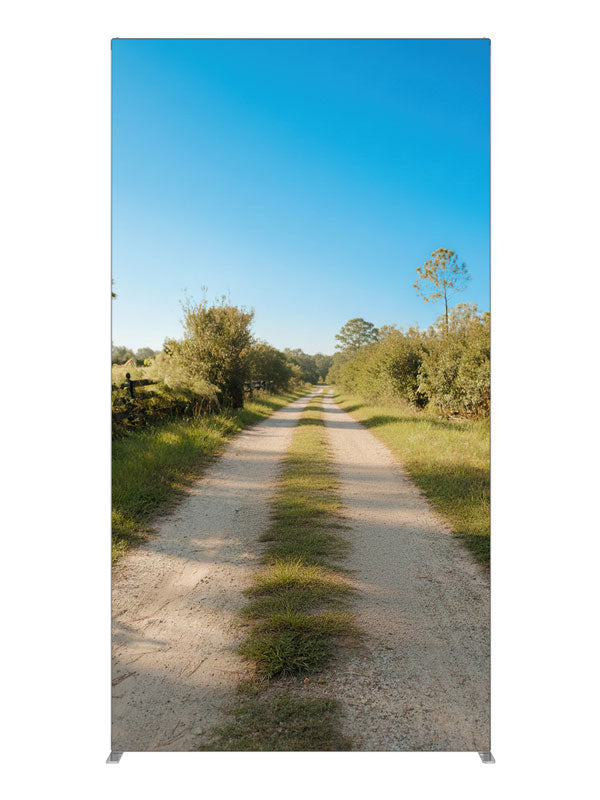 A sunny rural dirt lane between green fields with a split-rail fence under a blue sky, 4ft photography backdrop panel for Denny StudioEdge silicone edge frame