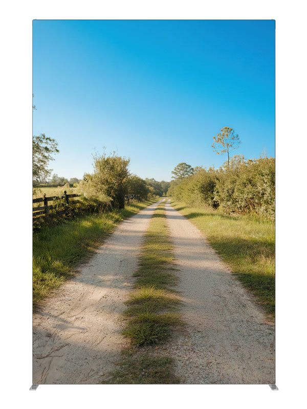 A sunny rural dirt lane between green fields with a split-rail fence under a blue sky, 5ft photography backdrop panel for Denny StudioEdge silicone edge frame