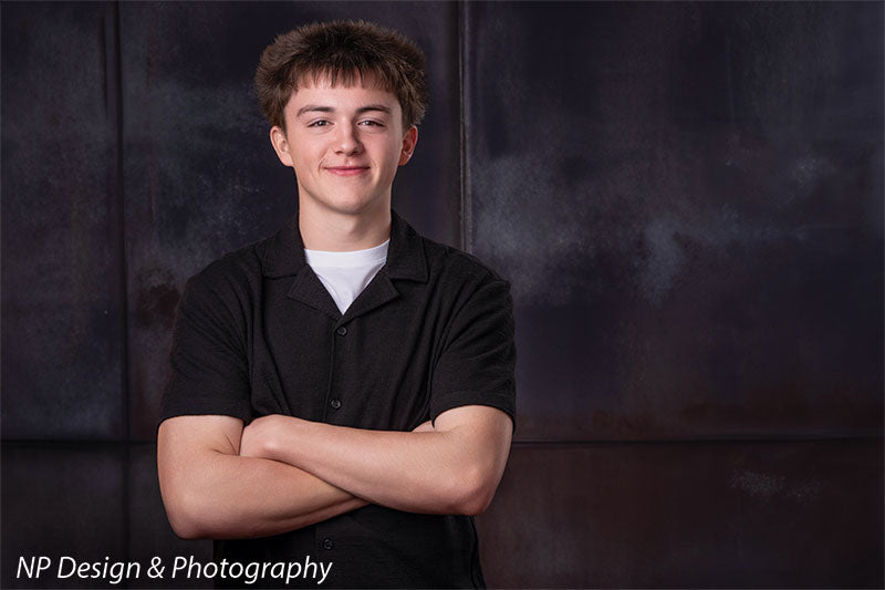 Rustic industrial metal panels photography backdrop shown with a senior boy standing with his arms crossed CP-8431